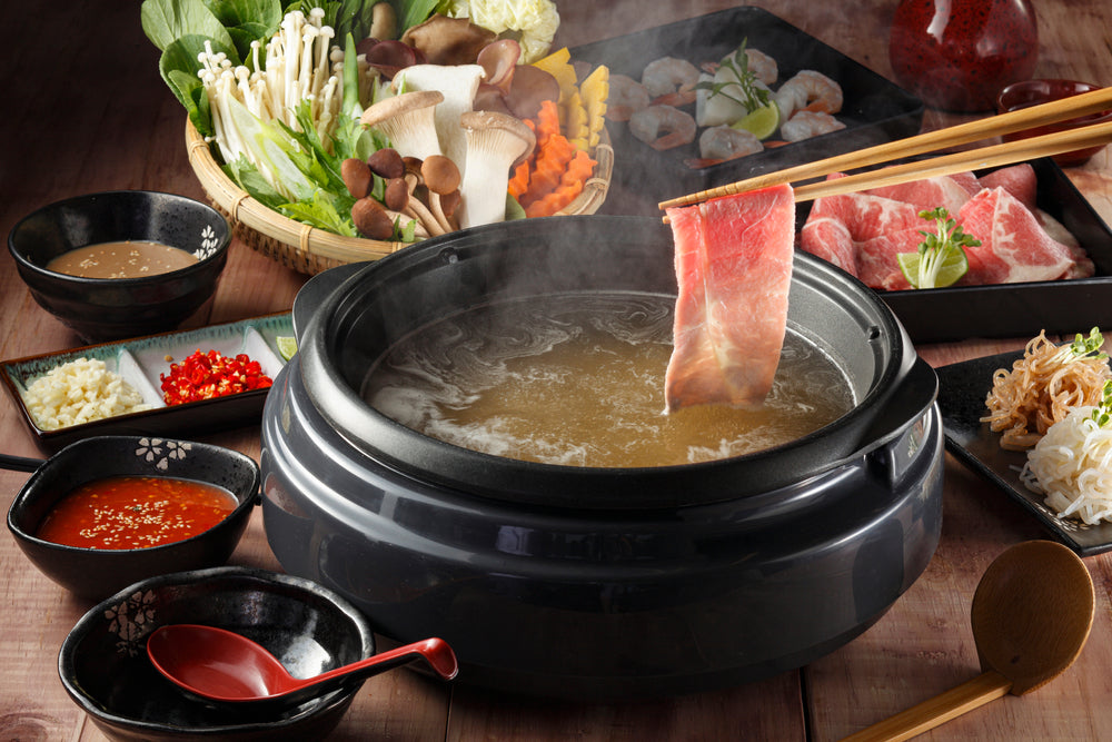 Chopstick holding beef shabu-shabu or sukiyaki. 