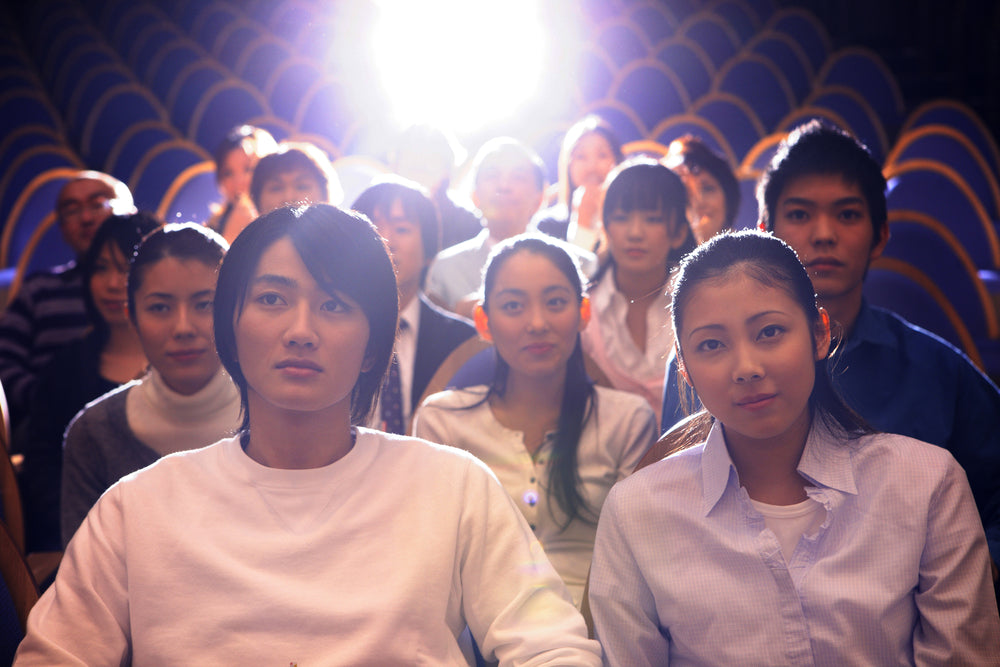 A couple at a Japanese movie theater.