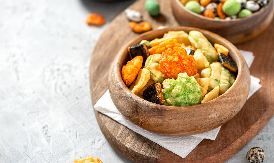 Rice crackers with wasabi and nori, peanuts with sesame seeds, and other snacks. Mix traditional Japanese snacks.