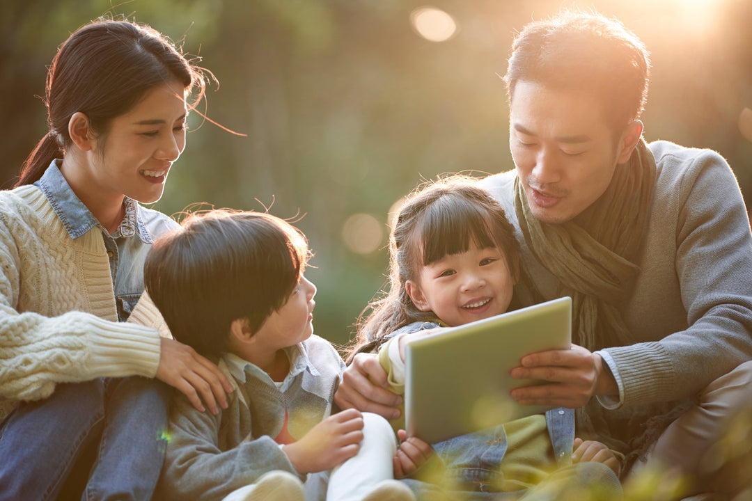 Family with two children enjoy time outdoors in a park