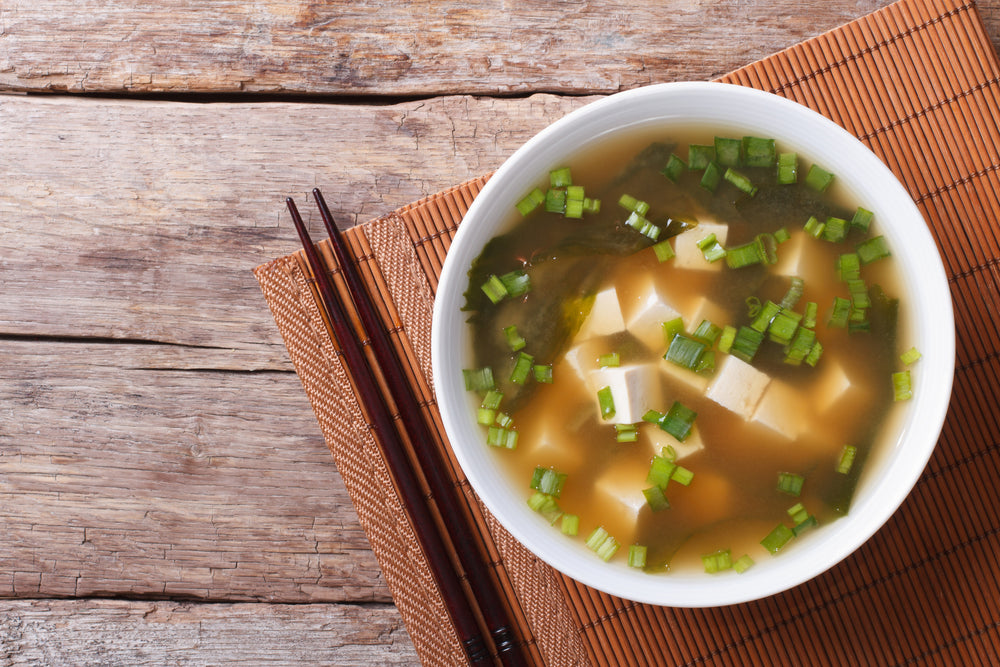 Bowl of miso soup with seaweed.